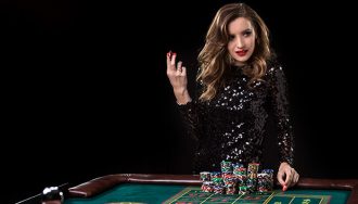 Woman at a roulette table with a stack of casino chips.