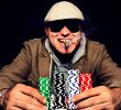 Player at Texas Hold’em table with a stack of poker chips.