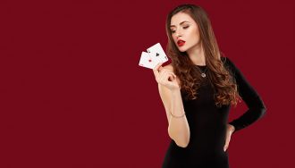 Woman holding a pair of aces