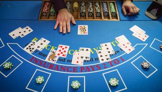 An image depicting a blackjack table with cards