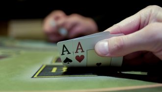 An image depicting a poker table with cards