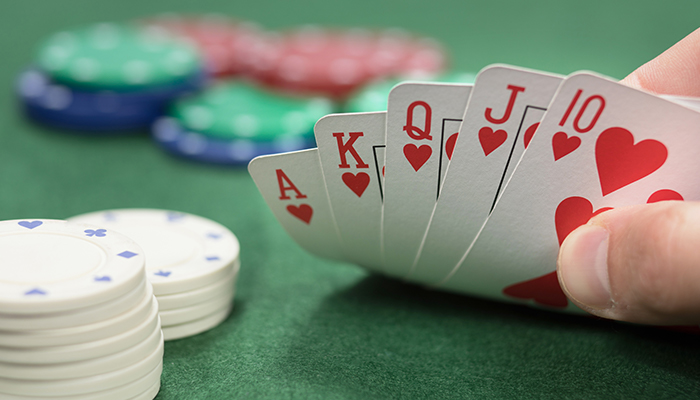 Straight flush hand of a poker player at a physical casino