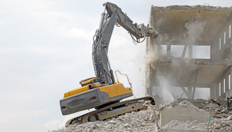 Building Being Demolished by Bulldozer