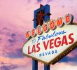 A close-up of the "Welcome to Fabulous Las Vegas, Nevada", with palm trees in the background under a clear sky.