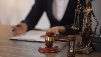 A lawyer discussing a legal document on a desk with a gavel and scales