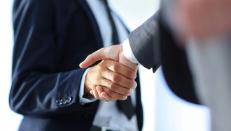 Businessman giving a handshake in the office