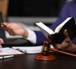 A picture of a courtroom with an attorney holding a book.