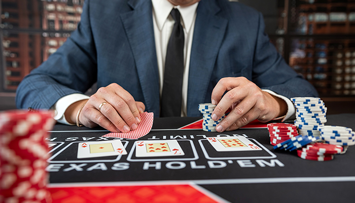 Poker player at a table with chips and cards