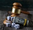 Justice gavel with dice and money