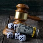 Justice gavel with dice and money