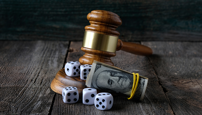 Justice gavel with dice and money